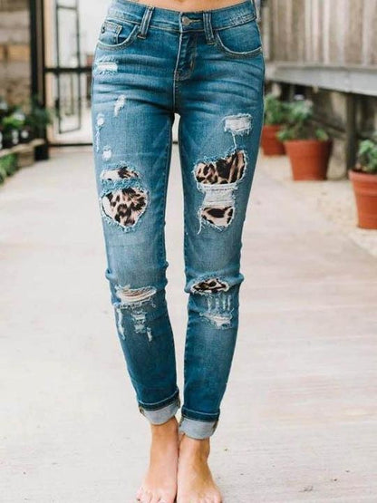 Ripped leopard print denim trousers for Women